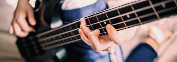 closeup of teenage girl playing bass